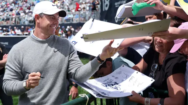 Rory McIlroy signs autographs for fans