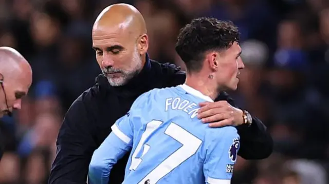 Phil Foden of Manchester City and Pep Guardiola Manager / Head Coach of Manchester City