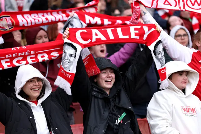 Fans wave scarves as they sing the Angel pre kick-off