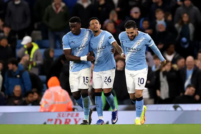 Savinho of Manchester City celebrates scoring his team's third goal with teammates Marc Guehi and Rayan Cherki