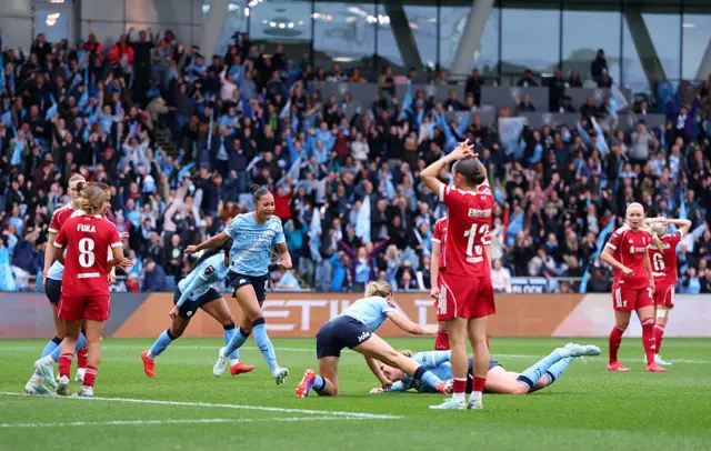 Knaak is mobbed after scoring a late winner v Liverpool