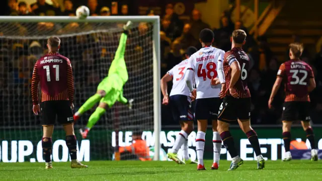 Bolton keeper Jack Bonham tips the ball onto the crossbar
