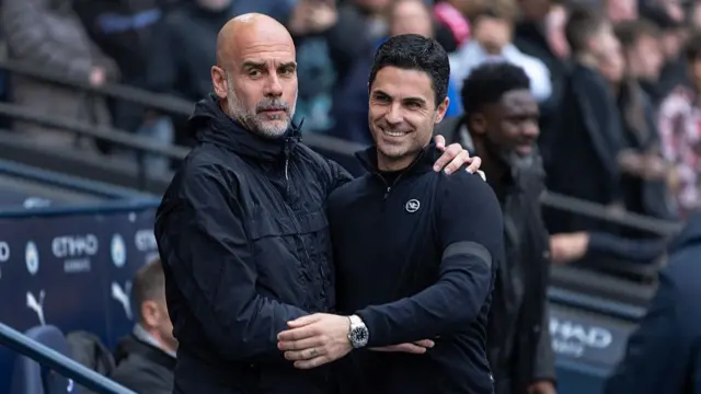 Pep Guardiola and Mikel Arteta embrace