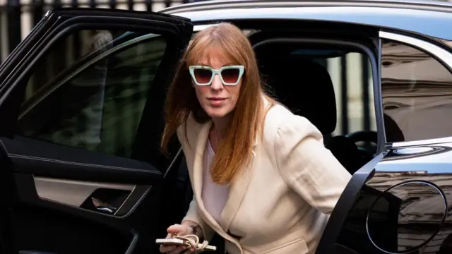 Angela Rayner, wearing sunglasses, steps out of a black car