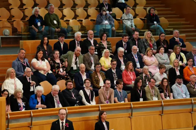 Crowd of people observing the Scottish Parliament swearing-in ceremony