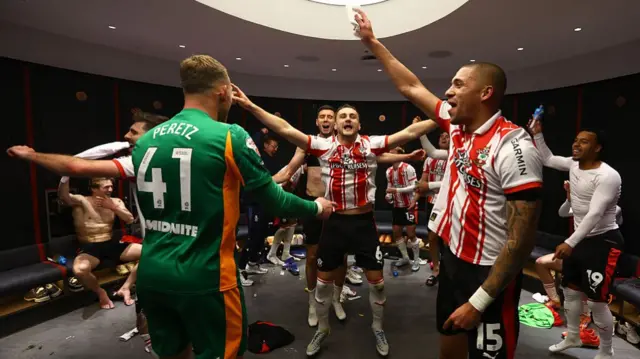 Taylor Harwood-Bellis and Southampton team mates celebrate in the dressing room after beating Middlesbrough
