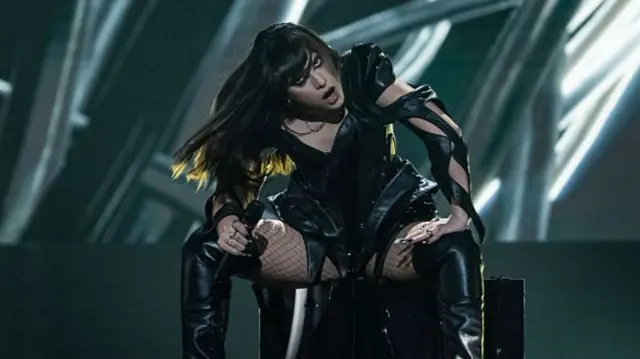 Romania's Alexandra Căpitănescu performs on stage in a black leather-look outfit