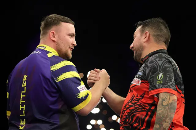 Luke Littler shaking hands with Jonny Clayton
