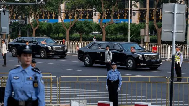 The motorcade of U.S. President Donald Trump travels by on its way to a State Dinner at the Great Hall of the People on May 14, 2026