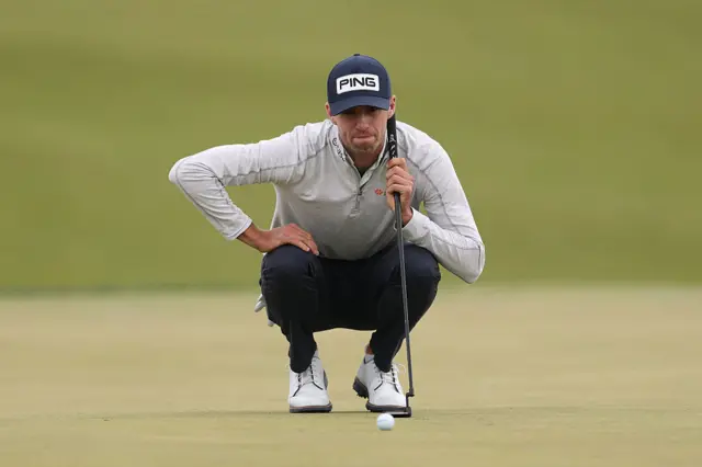 Alex Smalley lines up a putt