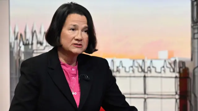 Catherine West in black blazer and pink shirt