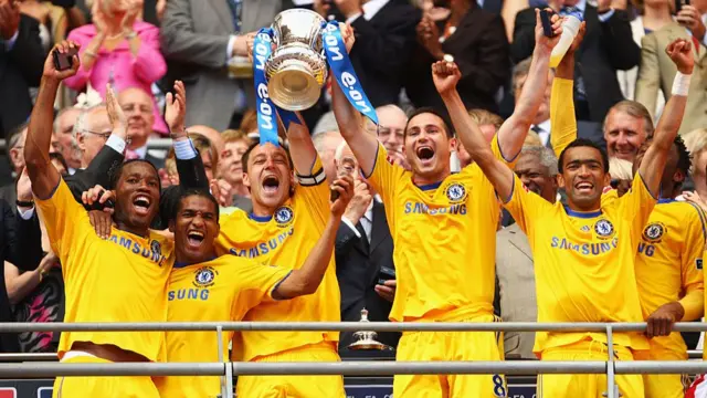 Captain John Terry (3rdL) of Chelsea lifts the trophy with Frank Lampard