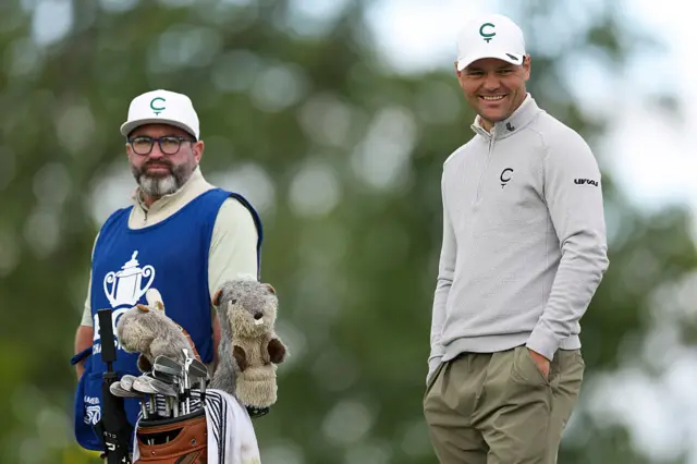 Martin Kaymer grins with his caddie