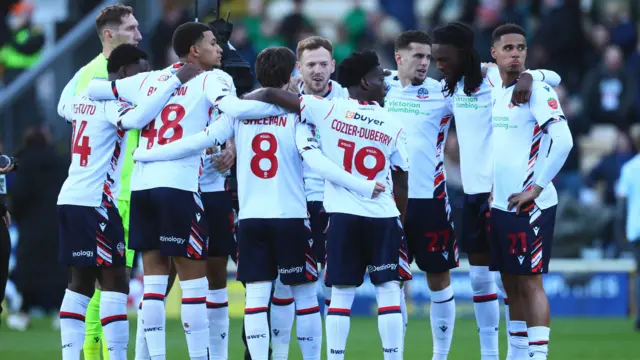 Bolton players break from the team huddle