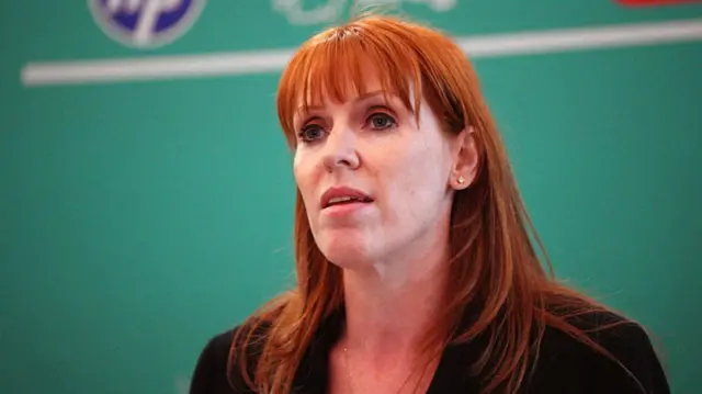 Angela Rayner pictured in front of green background
