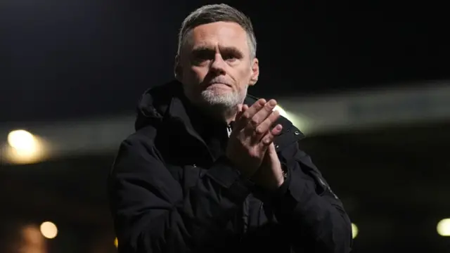 Bradford boss Graham Alexander claps the home support