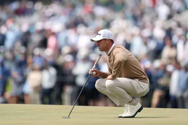 Justin Thomas lines up a putt