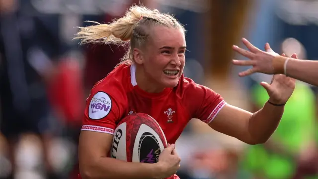 Seren Singleton runs with the ball for Wales