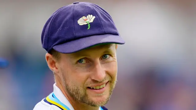 Yorkshire's Joe Root looking on from the slip cordon wearing a cap with the white rose badge on it.