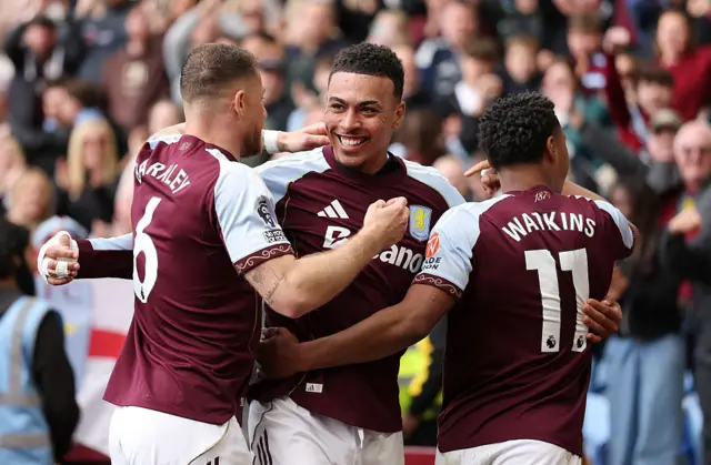 Morgan Rogers of Aston Villa celebrates scoring his team's third goal with teammates Ross Barkley and Ollie Watkins during the Premier League match between Aston Villa and Sunderland at Villa Park on April 19, 2026 in Birmingham, England. (Photo by Dan