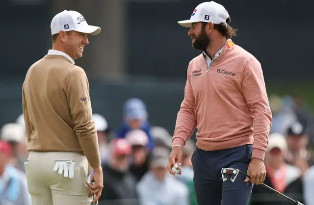 Justin Thomas grins at Cameron Young