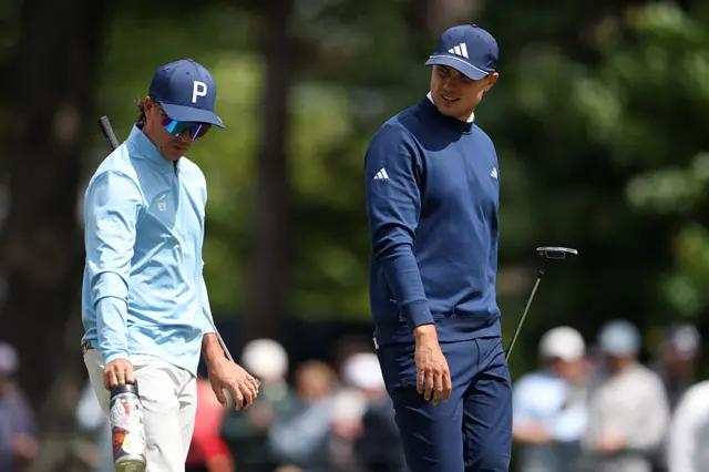 Ludvig Aberg and Rickie Fowler walk together between holes