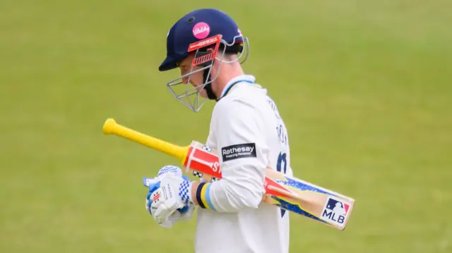 Yorkshire's Harry Brook walking with his bat under his arm after being dismissed against Surrey.