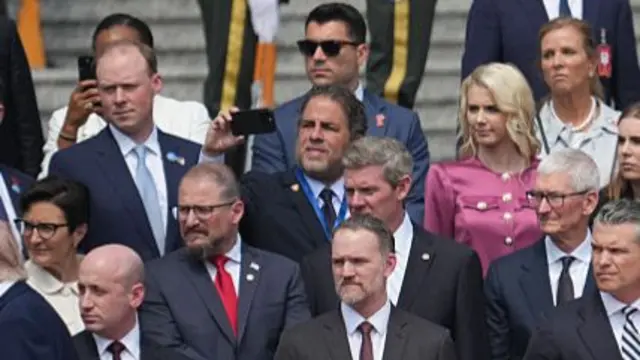 Rows of men and women dressed in formal suits