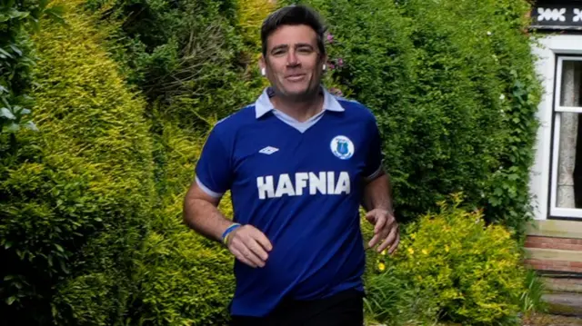 Mayor of Greater Manchester Andy Burnham outside his house in Warrington.