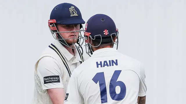Warwickshire batters Dan Mousley and Sam Hain share an exchange while batting