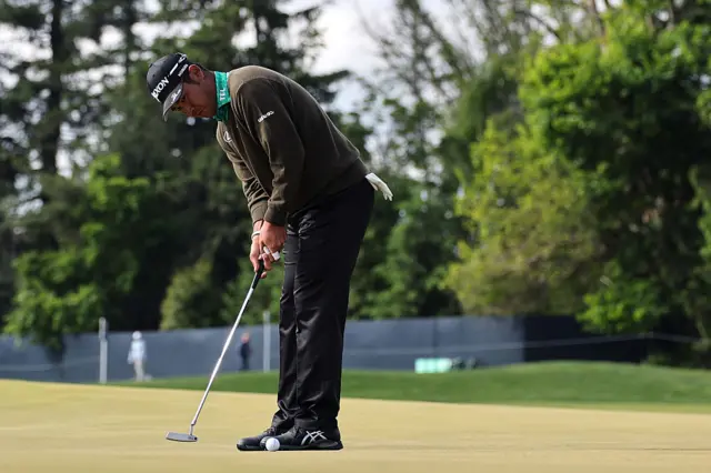 Hideki Matsuyama makes a putt