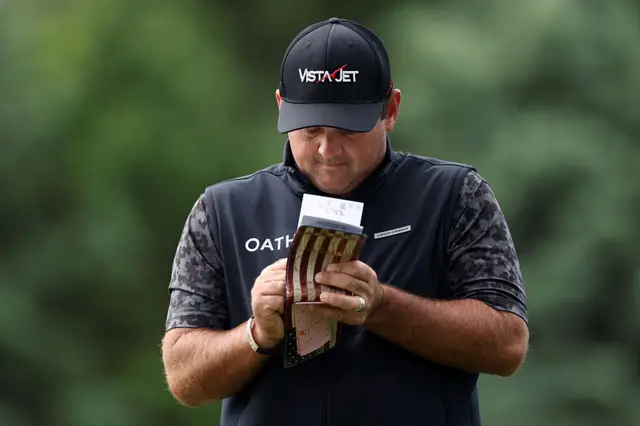 Patrick Reed makes notes