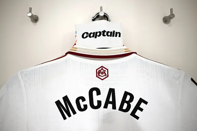 Katie McCabe shirt and armband hangs in the dressing room