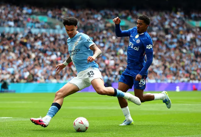 Nico O'Reilly of Manchester City is challenged by Wesley Fofana