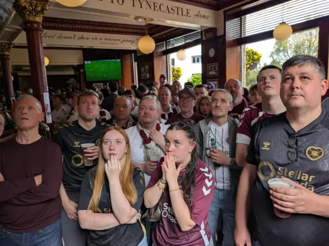 Hearts fans watching the match in a pub