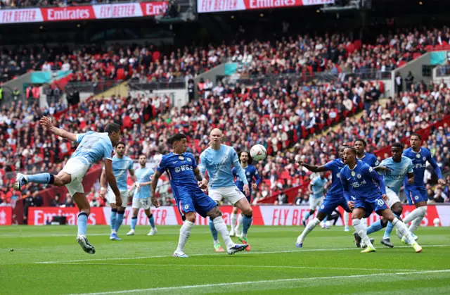 Rodri of Manchester Cityheads the ball into the box