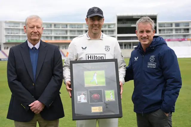 Cricket Operations Manager Tim Tremlett, Kyle Abbott and Hampshire Director of Cricket Giles White at a presentation to the fast bowler's 500th first-class wicket