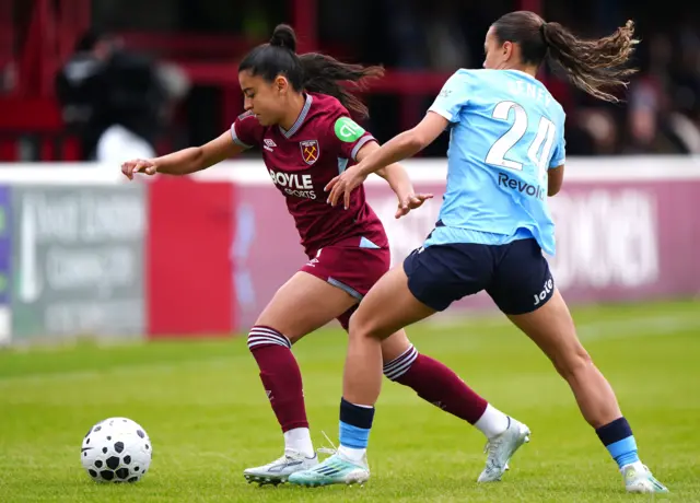 Ines Belloumou (left) and Manchester City's Iman Beney battle for the ball