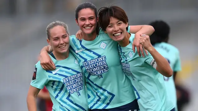 Lotta Lindstroem (L), Freya Godfrey and Saki Kumagai (R) of London City Lionesses celebrate