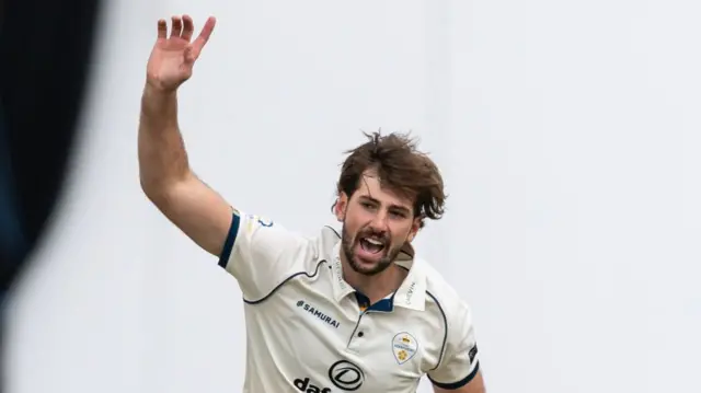 Ben Aitchison takes a wicket for Derbyshire