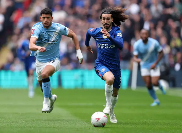 Marc Cucurella of Chelsea runs with the ball under pressure from Matheus Nunes