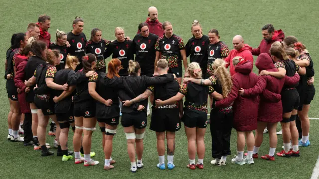 Wales in a huddle after their team run ahead of the fixture against Italy