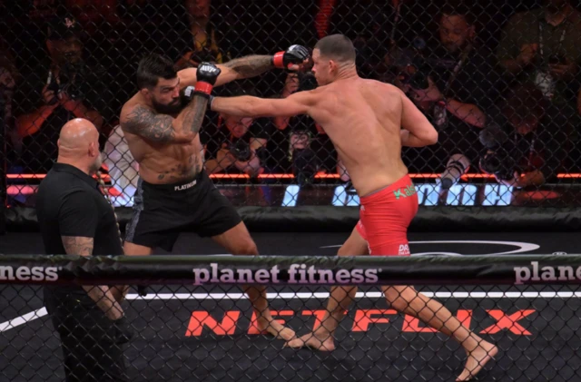 Nate Diaz punches Mike Perry who covers up