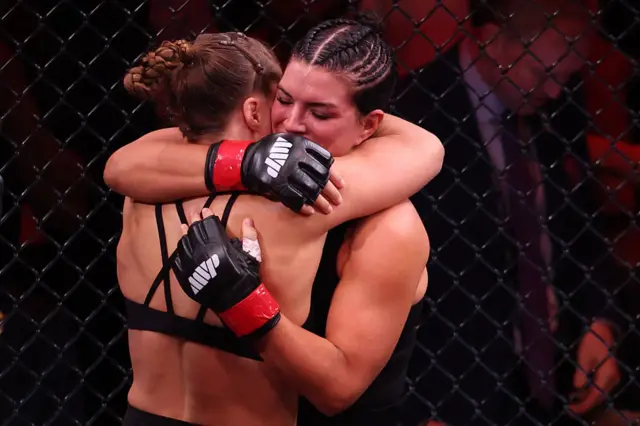Gina Carano hugs Ronda Rousey