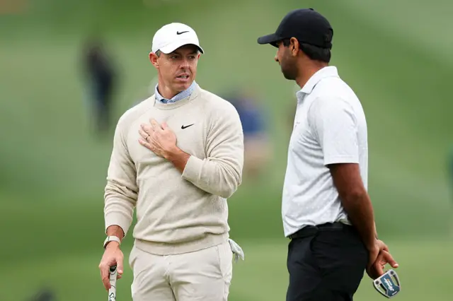 Rory McIlroy speaks to Aaron Rai
