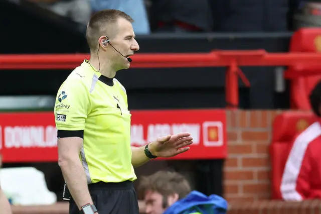 Referee Michael Salisbury is sent to the screen to have a look at this.