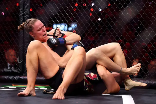 Ronda Rousey uses an armbar on Gina Carano
