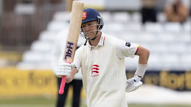 Jamie Porter raises his bat after reaching 50 for Essex