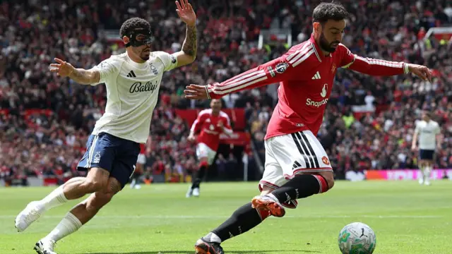 Gibbs-White and a Manchester United player contest for the ball