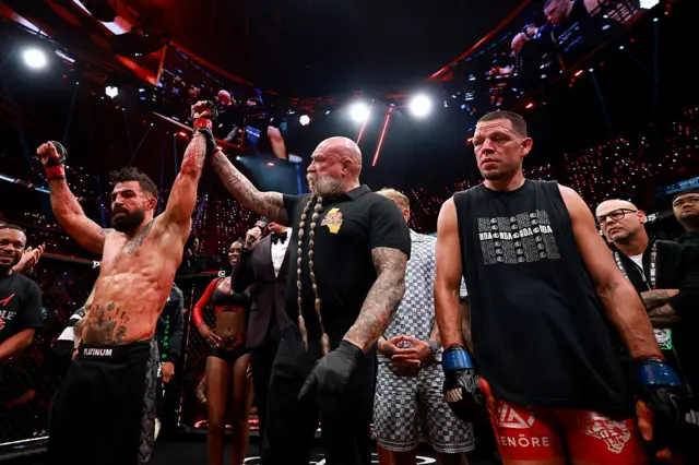 Mike Perry has his hand raised
